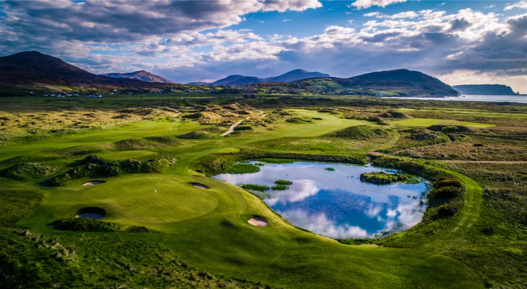 Stunning aerial view of a golf course, featuring lush greens, sand traps, and a serene pond. Perfect for golfers.